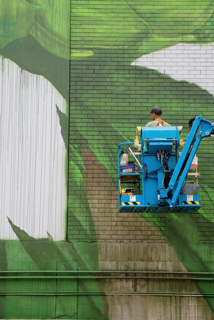 Cam Scale Mural Progress mural artist, Cam Scale adding detail to a large scale mural at the Burleigh Brewing Taphouse